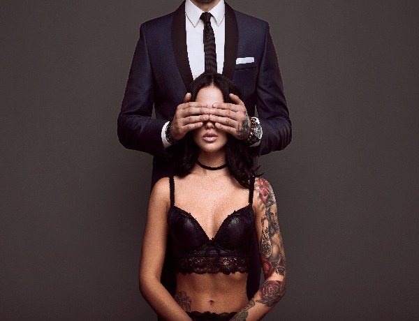 m_portrait-of-a-businessman-in-elegant-suit-cover-eyes-of-sexy-woman-with-a-tattoo-in-lingerie